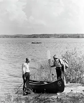 Canoeing: 1940s 1950s Two Men Standing By