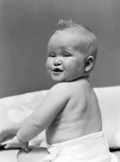 Diapers: 1940s BABY IN DIAPER LOOKING BACK OVER SHOULDER