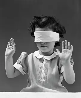 Sightless: 1940s Child Wearing Blind Fold With Hands In The Air