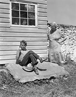 Inhaling: 1940s Farm Boy Leaning Against