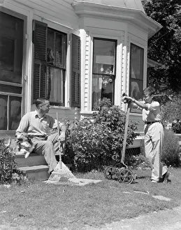 Lawnmower: 1940s Father Sits On Porch Steps