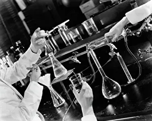 Beakers: 1940s - Hands Holding Beakers Doing Experiment Laboratory