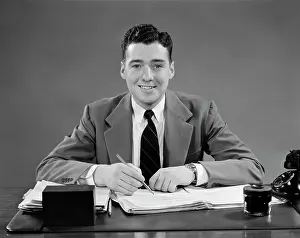 1940s Man Sitting At Desk In Office