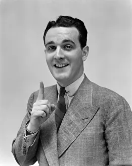 Natty: 1940s Man In Suit Holding Up Index