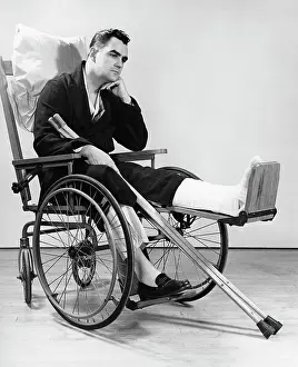 Insured: 1940s Man In Wheelchair With Cast