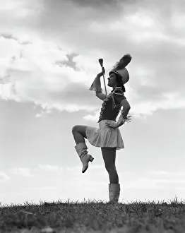 Marcher: 1940s SILHOUETTE OF MAJORETTE AGAINST SKY AND
