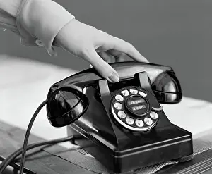 Desktop: 1940s WOMAN'S HAND PICKING UP PHONE RECEIVER