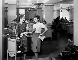 Steno: 1940s TWO WOMEN OFFICE WORKERS STANDING BY OFFICE