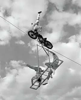 Coordinate: 1950s 1960s HIGH-WIRE ACT WITH MAN STANDING ON
