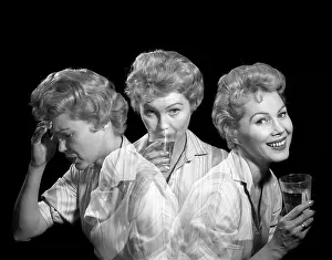 Sufferer: 1950s 1960s MULTIPLE EXPOSURE WOMAN WITH A HEADACHE