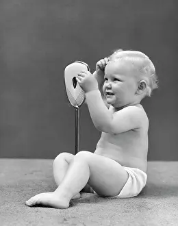 Fascination: 1950s Baby Holding Mirror Looking