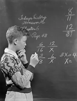 Multiplication: 1950s BOY AT BLACKBOARD DOING MATH MULTIPLICATION