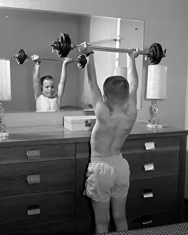 Dumbbell: 1950s Boy Exercising With Dumbbell
