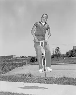 Crewcut: 1950s Boy Jumping On Pogo Stick