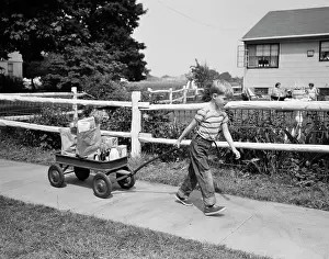Sneaker: 1950s BOY PULLING GROCERIES IN WAGON