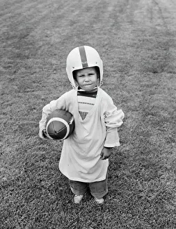 Lef001: 1950s BOY STANDING IN GRASS WEARING OVERSIZED