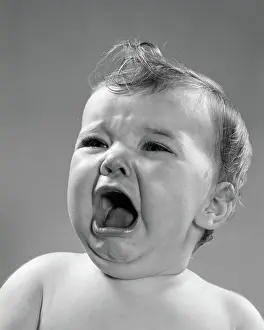 Sobbing: 1950s CLOSE-UP OF BABY SCREAMING & CRYING WITH