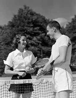 Raquets: 1950s Couple Standing On Opposite