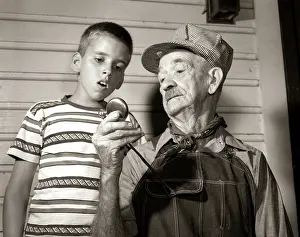 Grandparent: 1950s Elderly Man Grandfather Train Engineer Holding up P