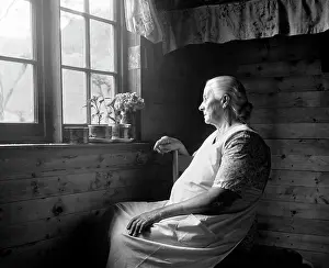 Dimly: 1950s Elderly Woman Seated In