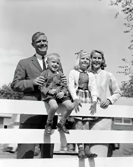 Foursome: 1950s Family Of Four Behind Backyard
