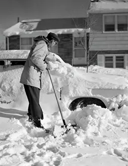 Shoveling: 1950s Man In Front Of House Shoveling