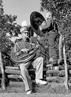 Tubas: 1950s Man Playing A Tuba Sitting