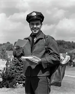 Mailman: 1950s MAN SMILING POSTMAN HOLDING OUT LETTER