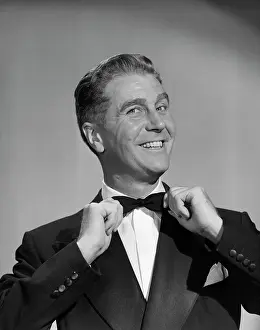 Debonair: 1950s Man Smiling In Tuxedo Pulling