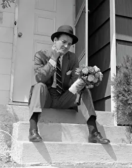 Hopeless: 1950s Man In Suit And Hat Holding