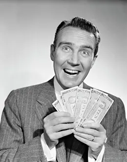 Windfall: 1950s Man In Suit Holding Money