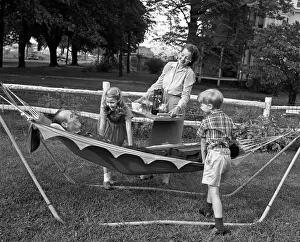 Spoiled: 1950s MOM & KIDS SERVING DAD IN HAMMOCK