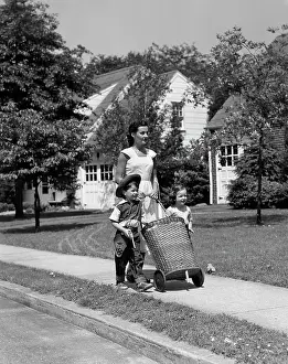 Errand: 1950s Mom On Sidewalk Pushing