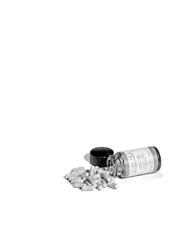 Prescription: 1950s pill bottle on it's side next to pile of