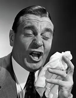 Sneeze: 1950s PORTRAIT OF MAN ABOUT TO SNEEZE MOVING