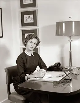 Receptionist: 1950s Receptionist Seated At Desk