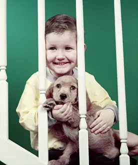 Banisters: 1950s Smiling Little Boy Holding