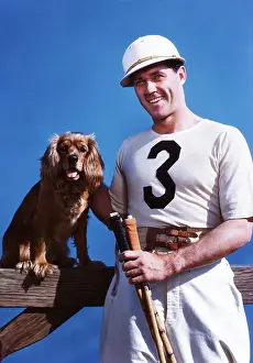 Numeral: 1950s SMILING MAN POLO PLAYER POSING WITH COCKER