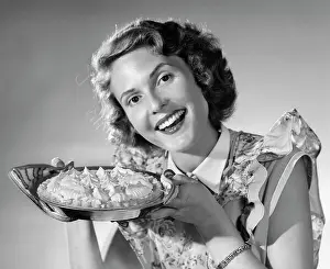 Meringue: 1950s Smiling Woman Presenting