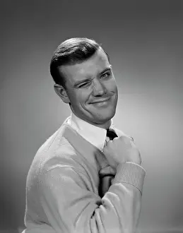 Wink: 1950s SMILING YOUNG MAN WINKING RIGHT EYE AND