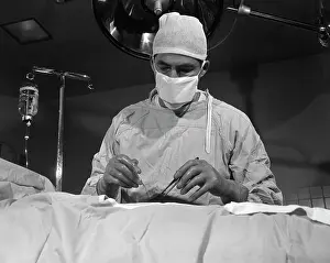 Sterile: 1950s SURGEON STANDING INSIDE OPERATING ROOM