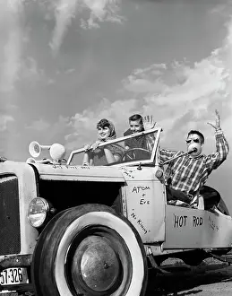 1950s TEENS IN ROOFLESS HOTROD WITH GRAFFITI