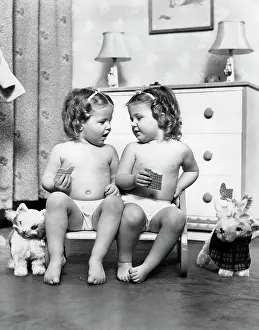 Siting: 1950s Twin Girls Siting In A Double