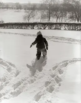 Snowsuit: 1950s BACK VIEW CHILD IN SNOWSUIT MAKING TRACKS