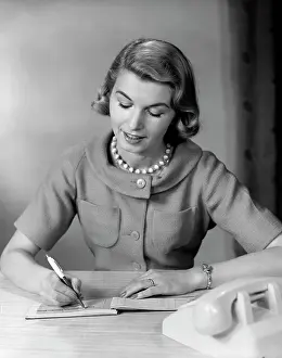 Checkbook: 1950s Woman Balancing Checkbook