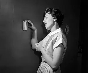 Thermostat: 1950s Woman Using Thermostat
