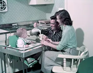Highchair: 1950s Young Family In Kitchen