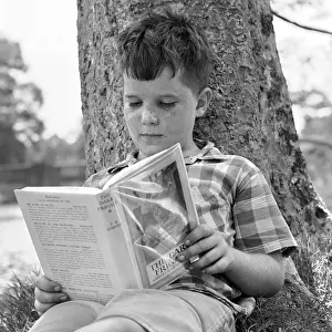 Literate: 1960s 1970s Boy Leaning Against