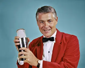 Server: 1960s 1970s Smiling Man Bartender in Red Jacket looking a