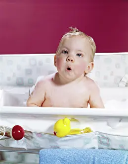 Layette: 1960s Baby In Layette Bath Making Funny Face